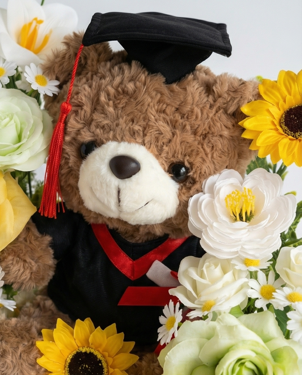 Graduation-themed teddy bear with flowers in a clear gift bag, teddy bear close up