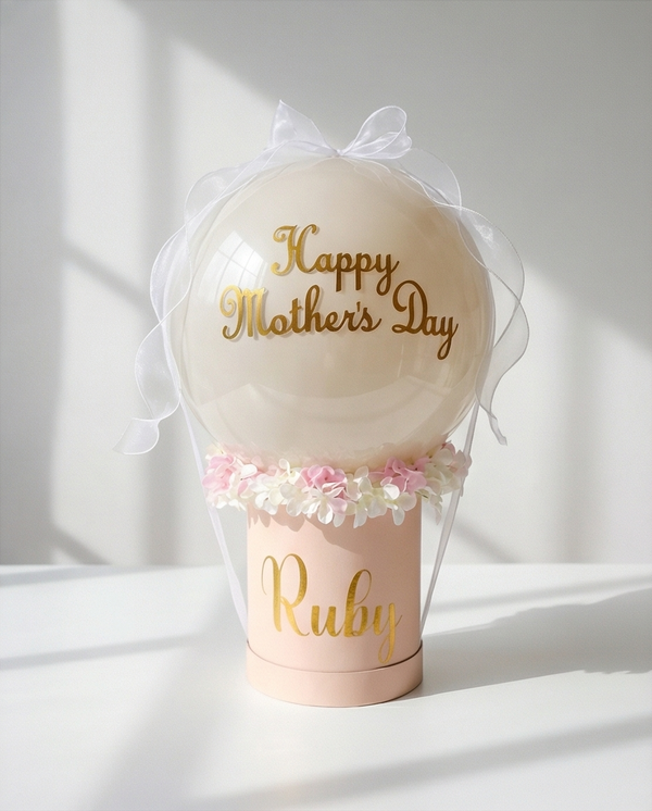 Decorative balloon with 'Happy Mother's Day' text and floral accents in a pink holder, full product view