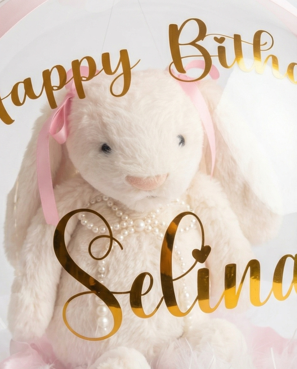 Teddy bear in a clear dome with pink ribbons, close up of teddy bear
