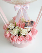 Decorative birthday balloon with flowers and balloons inside, top flower close up