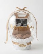 Baby shower gift with baby onesie, socks, and ultrasound photo inside a decorative box, slight zoom view