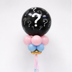 Black balloon with question marks and colorful base, close up balloon