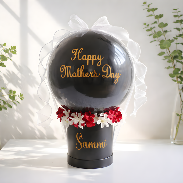 Black balloon with 'Happy Mother's Day' text and flowers, placed in a decorative box, full product view